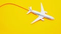 Close-up White passenger plane in flight on a beautiful yellow pastel background, flying with a contrail, copy space. Airline Royalty Free Stock Photo
