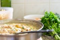 Close up of white pasta sauce dish in frying pan on kitchen bench ready to be served