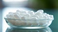 Close up of white pills spilling out of pill bottle on blurred background Royalty Free Stock Photo
