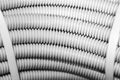 Close up white plastic corrugated pipe is aspart cable coil and is used for protective electric cables and etherne Royalty Free Stock Photo