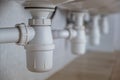 Close up of white plastic pipe drain under washing sink in bathroom