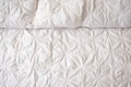 close up of white quilted bedding top view