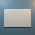 A close up of a white rectangular object with rounded corners against a blue textured background wall Royalty Free Stock Photo