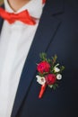 Close up of white and red rose corsage on man suit Royalty Free Stock Photo