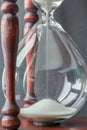 Close up white sand flowing motion of vintage wooden hourglass w Royalty Free Stock Photo