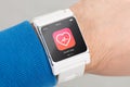 Close up white smart watch with health app icon