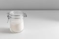 close up of white sugar glass jar on table