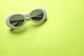 Close up  white sunglasses isolate on a green background Royalty Free Stock Photo