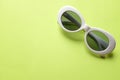 Close up  white sunglasses isolate on a green background Royalty Free Stock Photo