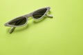 Close up  white sunglasses isolate on a green background Royalty Free Stock Photo