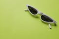 Close up  white sunglasses isolate on a green background Royalty Free Stock Photo