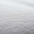 A close-up of a white textured surface, likely fabric or paper. The image highlights the Royalty Free Stock Photo