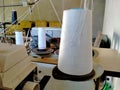 The close up of white a thread the yarn is displaying on the right side of the machine table sewing occurs in the home industry Royalty Free Stock Photo