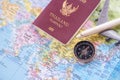 Close up the white toy airplane and passport on the world map ba Royalty Free Stock Photo