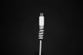 Close-up of white USB type-c charge connector with cable protection on black background. Royalty Free Stock Photo