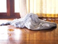 White used towel on wooden brown floor in bedroom
