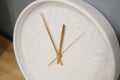 Close up white watch clock gold arrow