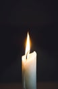 Close up of white wax lit candle flame and wick on black background. candle lights macro. closeup of burning candle isolated on Royalty Free Stock Photo