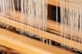 Close up of white weaving threads on wooden loom.. Royalty Free Stock Photo
