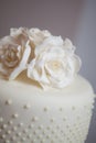 Close up of a White wedding cake with flowers decorating the top
