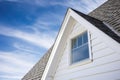 close-up of white window trim on gambrel roof house