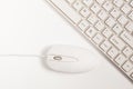 Close up of white wireless keyboard and wired mouse Royalty Free Stock Photo