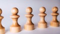 Close up of white wooden chess pieces. Row of white pawns on white background Royalty Free Stock Photo