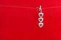 Close up of White wooden heart simbol on red paper background