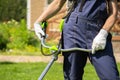 A close up of a white young man moving a lawn with a lawn mower in his hands Royalty Free Stock Photo