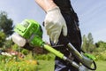 A close up of a white young man moving a lawn with a lawn mower in his hands Royalty Free Stock Photo