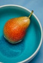 Close up of whole pear fruit in a bowl. View from top