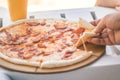 Close-up whole pizza with sausages and cheese. Beach food Royalty Free Stock Photo