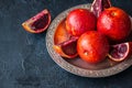 Close up of whole and slices of fresh and ripe blood oranges in Royalty Free Stock Photo