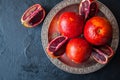 Close up of whole and slices of fresh and ripe blood oranges in Royalty Free Stock Photo