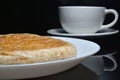 Close-up whole wheat bread on white dish and blur coffee cup.