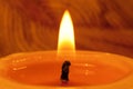 Close-up of wick and flame of burning candle on light backgroun Royalty Free Stock Photo