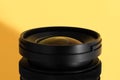 Close-up of an wide angle camera lens with glass reflections on yellow background Royalty Free Stock Photo