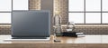 Close up of wide wooden designer office desk with empty computer, supplies and other objects. Blurry brick wall and window with Royalty Free Stock Photo