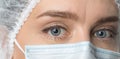 Close up widely opened eyes of doctor. Female doctor in protective mask with beautiful eyes close up. Royalty Free Stock Photo