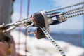 Close up on winch and rope of yacht over blue sea Royalty Free Stock Photo