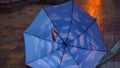 Close-up wind blowing umbrella on night city street outdoors. Close-up accessoire leaving in slow motion in twilight