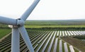 Close up of wind turbine with solar power station in the background Royalty Free Stock Photo