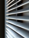 Close-up of window blinds showing horizontal slats and shadows. Royalty Free Stock Photo