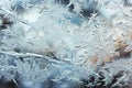 A close up of a window with water drops, frost and snow figures on an icy window in winter