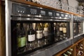 Close up of wine bottles in dispenser at bar