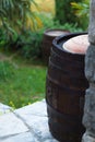 Close up of a wine cask at the winery garden. Wine barrel outside of wine cellar in the garden of a picturesque vineyard Royalty Free Stock Photo