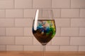 Close up of wine glass filled with clear liquid food coloring swirling Royalty Free Stock Photo