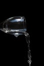 Close up wine glass pouring water, isolated on black background Royalty Free Stock Photo