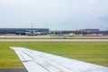 Close up of Wing of Airplane on Airplane waiting for Maintenance at the Airport Background