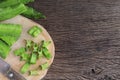 Close up of Winged bean or Psophocarpus tetragonolobus on a wooden cutting board on the wooden table.